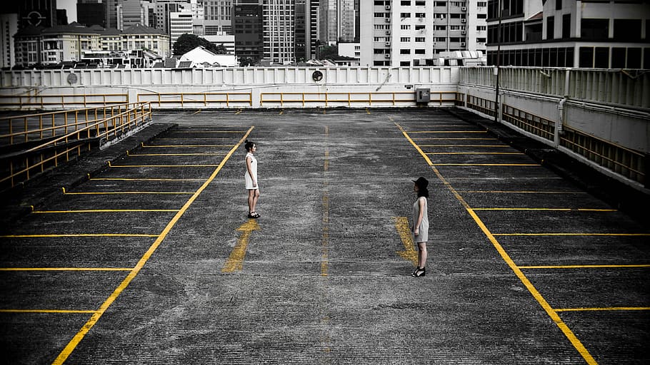 two, women, standing, empty, parking area, daytime, architecture, building, infrastructure, court