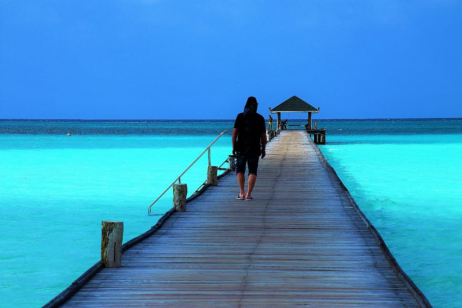man, walking, brown, dock, calm, water, daytime, maldives, the pier, bridge