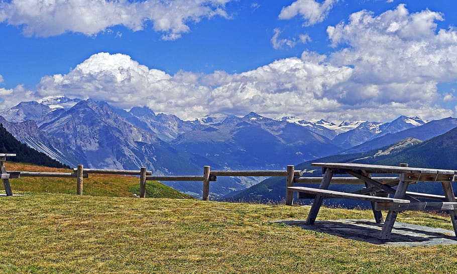 brown, wooden, picnic table, green, grass field, blue, white, sky, italy, southern alps