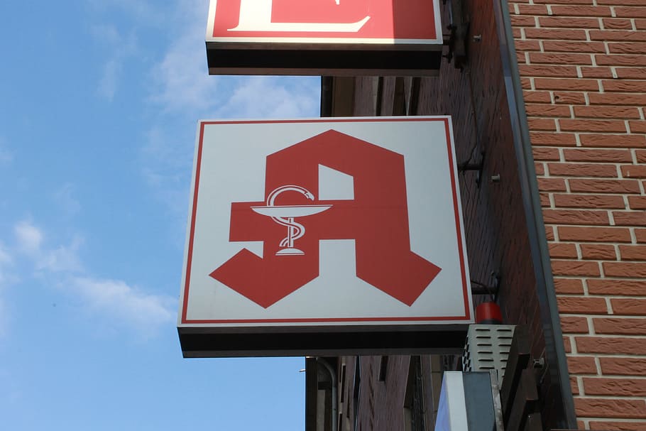 pharmacy, shield, logo, pharmacy sign, sign, communication, red, low angle view, building exterior, built structure