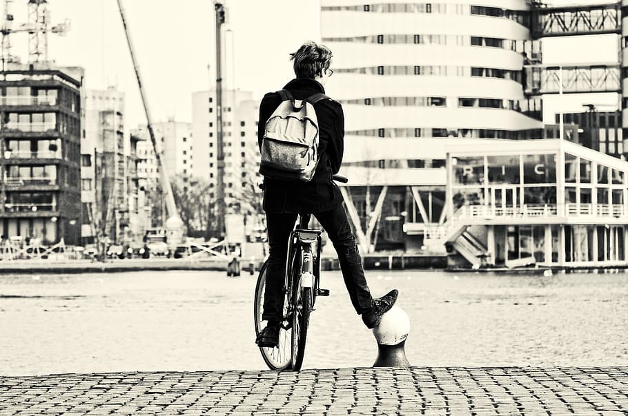grayscale photo, person, riding, bike, man, people, bicycle, standing, leg, support