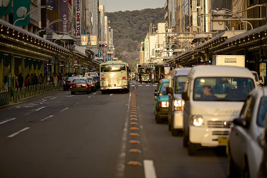 cars, busses, trucks, road, street, traffic, busy, city, buildings, stores
