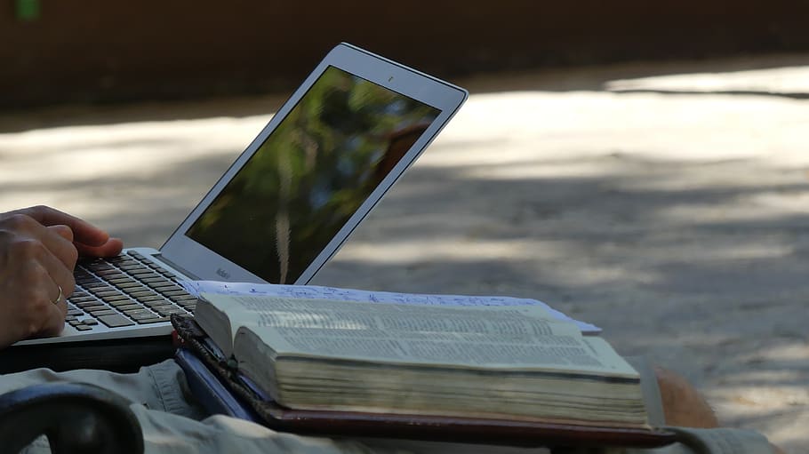 bible, laptop, computer, object, christ, human hand, one person, hand, human body part, holding