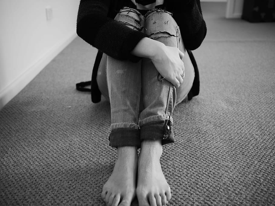 woman, sitting, floor, grayscale photography, grayscale, photography, vulnerable, ripped jeans, alone, sad