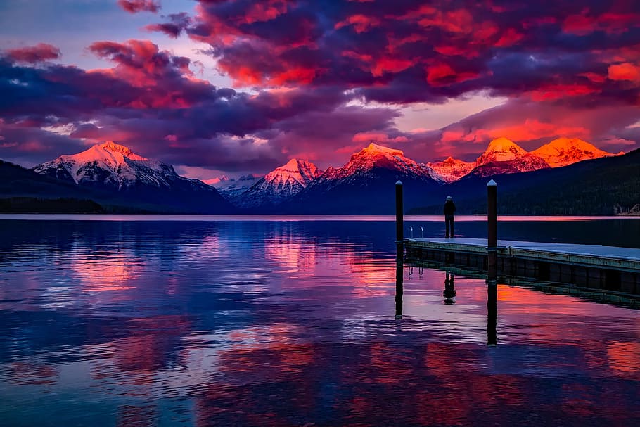 silhouette, person, standing, brown, dock, orange, sunset, lake mcdonald, glacier national park, montana