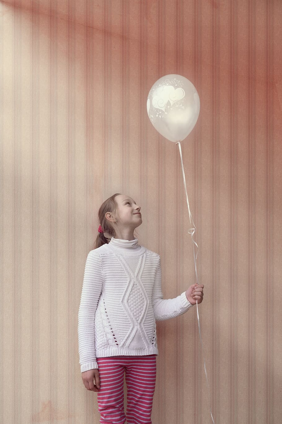 girl, standing, wall, holding, balloon string, balloon, happy, pink, young, party