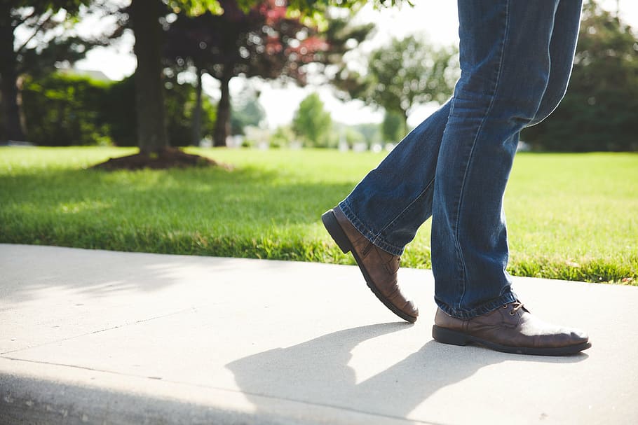 person, wearing, brown, leather dress shoes, blue, denim, jeans, walking, sidewalk, shoes