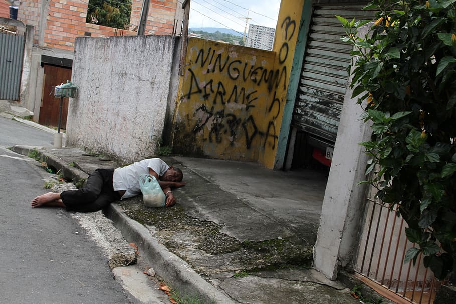 brazil, carapicuiba city, favela, community, street without sidewalks, pool of water, dead-end street, brazilian reality, the real brazil, man sleeping on the street