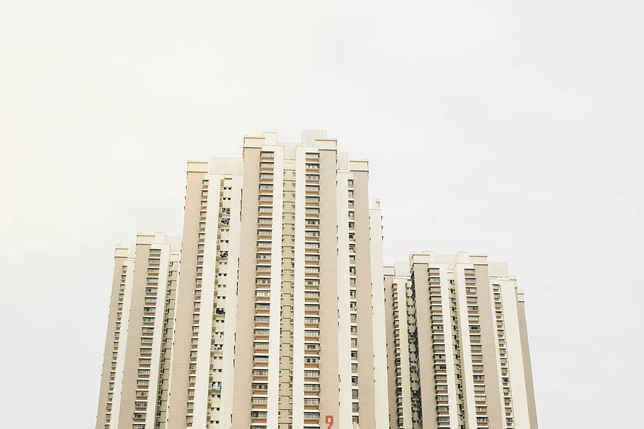 low, angle photo, beige, high-rise, building, cloudy, sky, daytime, far, high