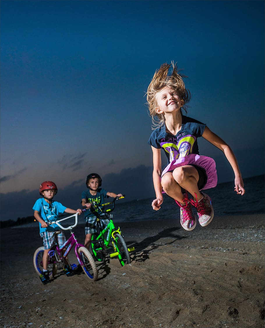 two, boy, bike, girl jumpig, seashore, night time, fun, child, lifestyle, active
