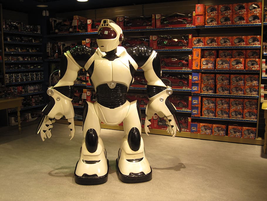white, black, robot, standing, next, grey, muscle rack, toy, store, giant