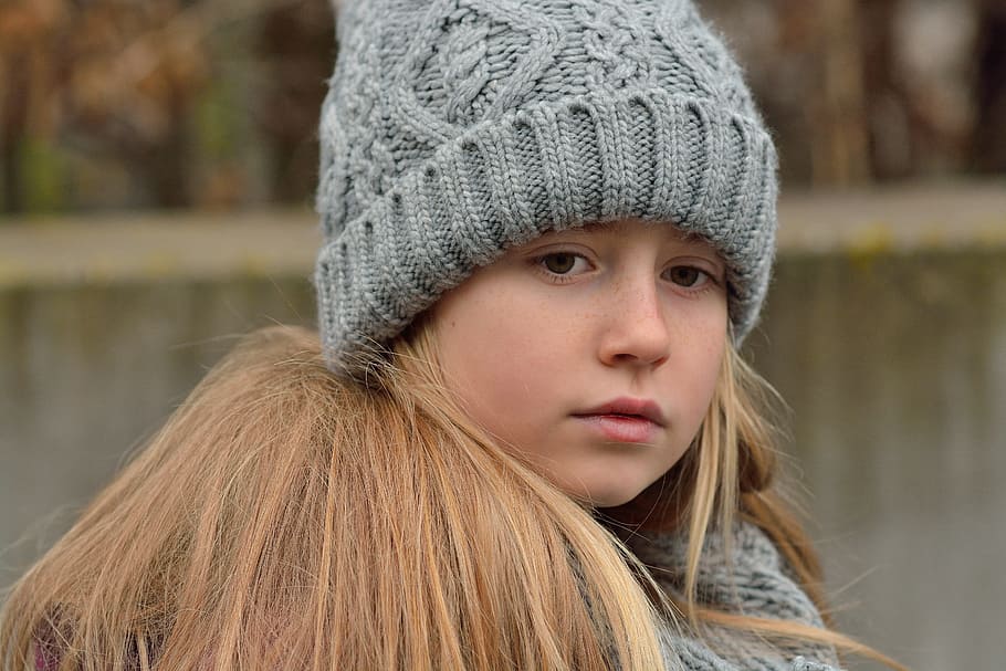 gray knitted beanie, child, girl, long hair, blond, cap, sad, thoughtful, distressed, grieves