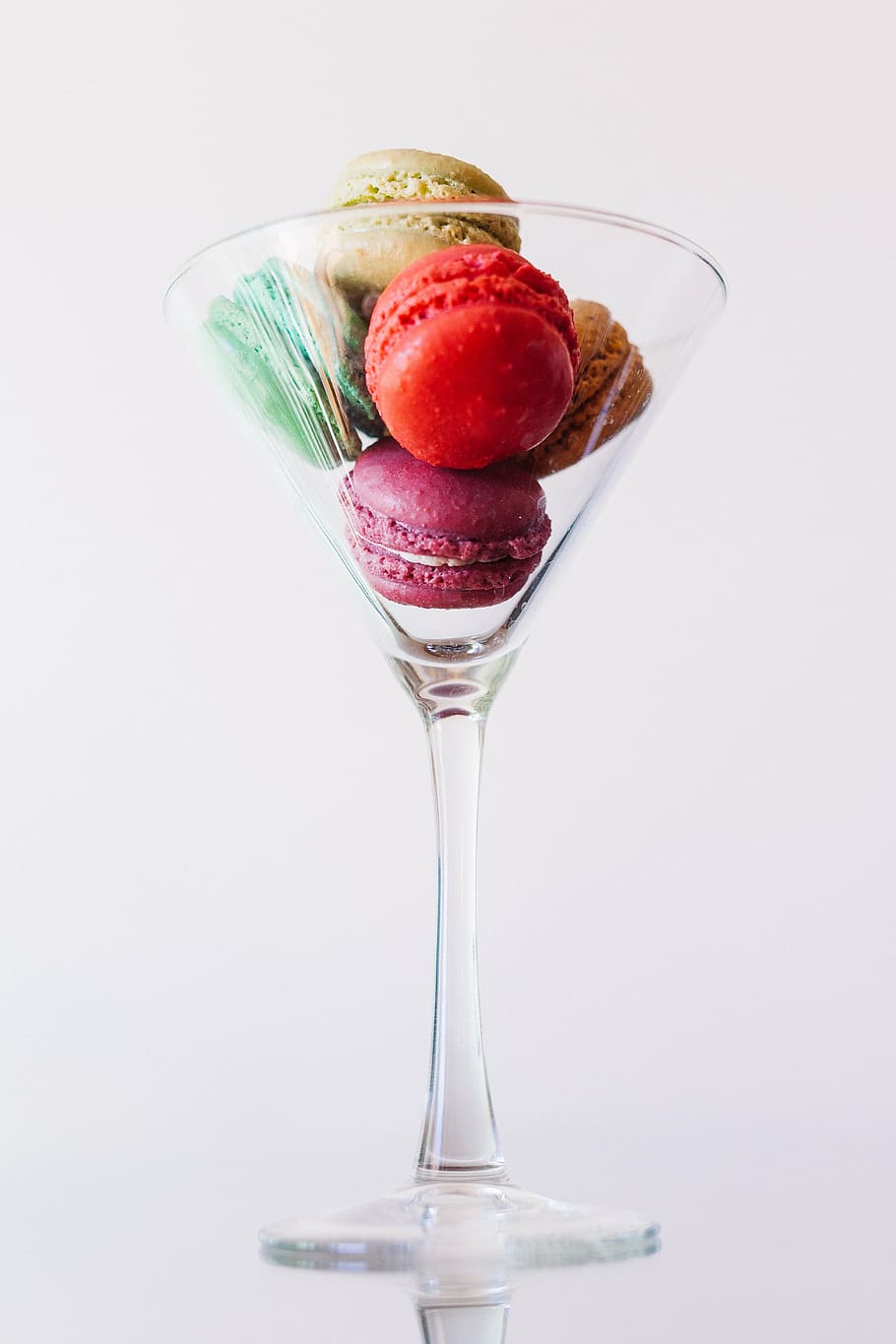 four, maracons, inside, clear, long-stem wine glass, close, cocktail, glass, burger, cookies