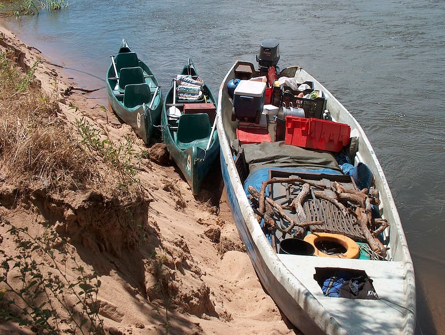 supplies, boat, canoe, zambezi river, river bank, grass, sand, water, power, environment
