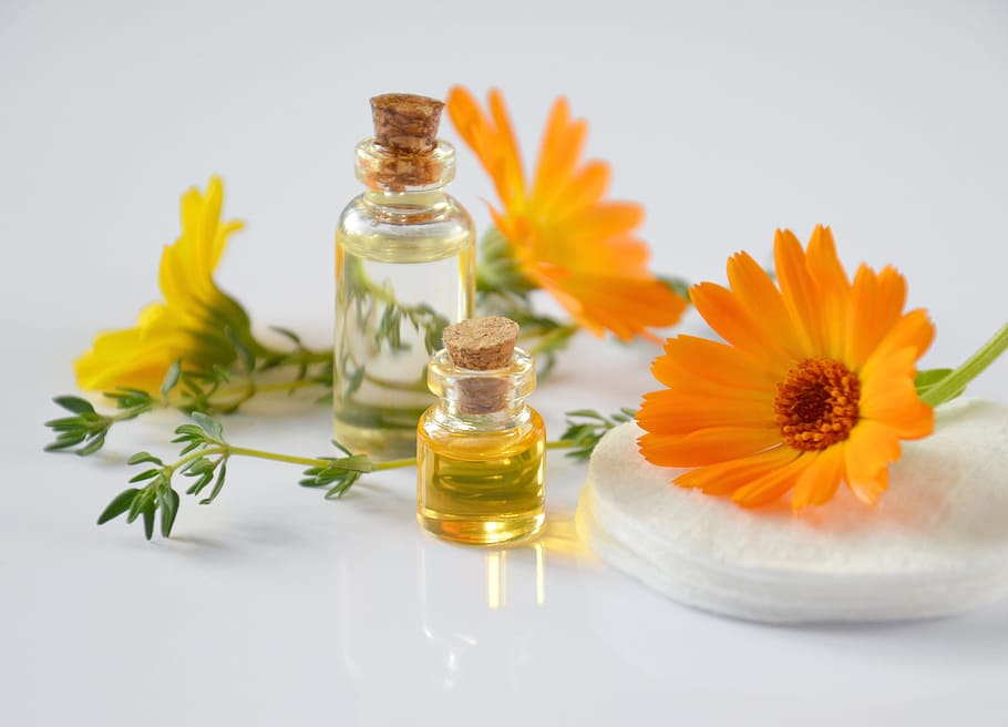 two glass bottles, cosmetology, oil cosmetic, calendula, cosmetics, science, essential oils, chemistry, orange flowers, petals