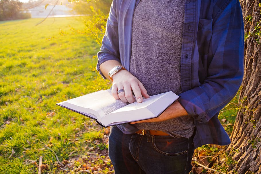 person holding book, man, gray, shirt, blue, long, sleeved, holding, book, guy