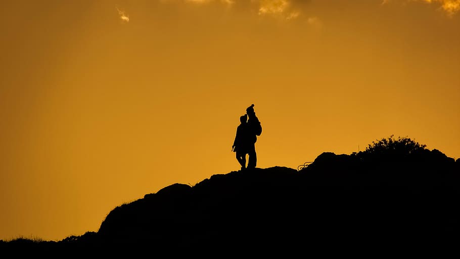 silhouette, man, standing, mountain, couple, cliff, afternoon, sunset colors, shadows, silhouettes