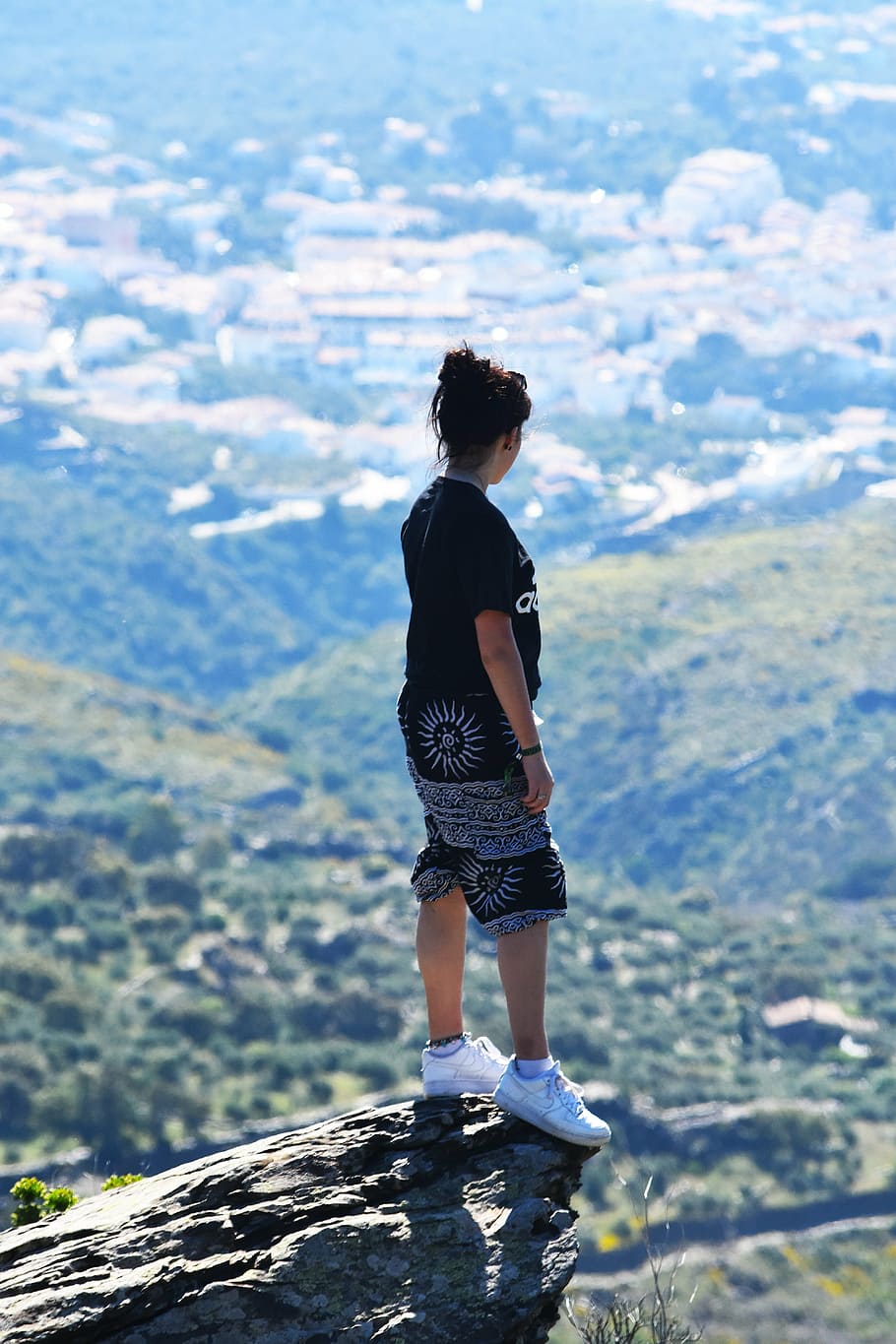 black, haired woman, top, shorts, mountain cliff, day time, mountainside, cliff edge, travel, cliff