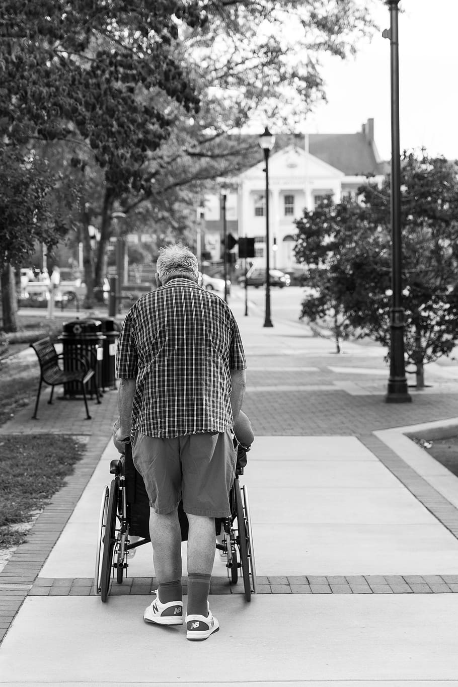 grayscale photo, man, pushing, wheelchair, people, street, adult, elderly, monochrome, couple