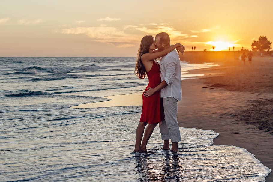 man, woman, standing, seashore, daytime, a couple of, young couple, love, kiss, kissing