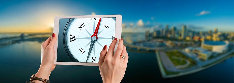 person, holding, powered-on ipad, compass display, compass, orientation, direction, city, success, businesswoman