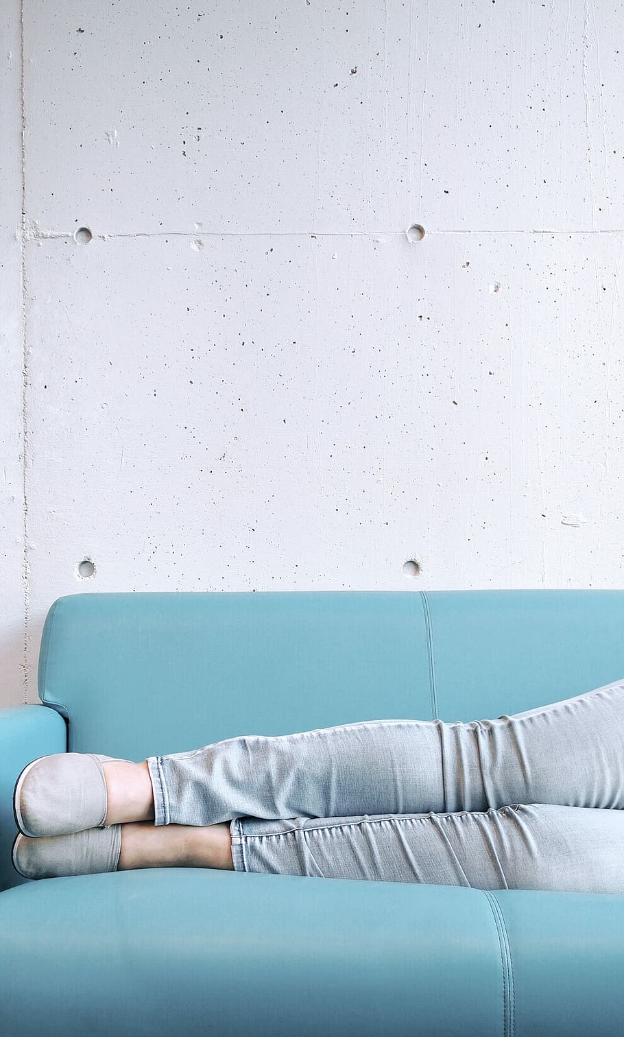 person, wearing, gray, skinny, jeans, slip, shoes, sky-blue couch, skinny jeans, slip on