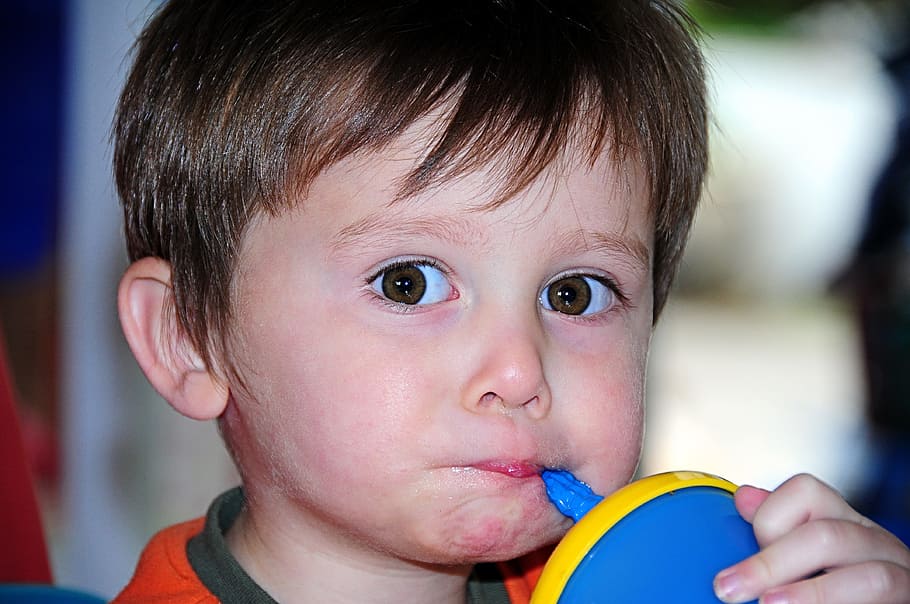 boy, sipping, blue, yellow, sippy cup, little, kid, child, big eyes, drinking
