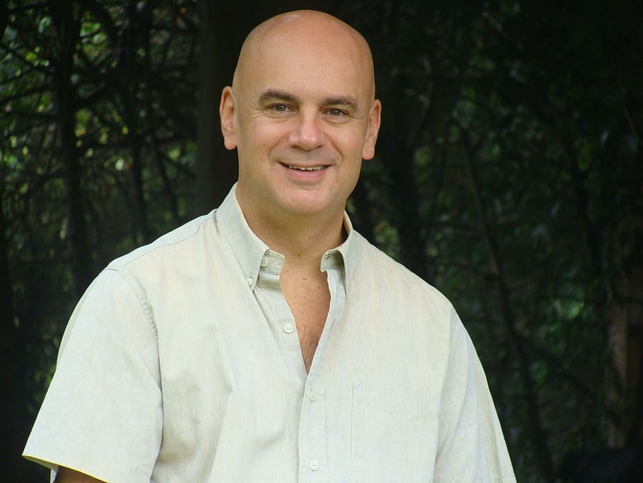 smiling, man, white, button-up t-shirt, trees, people, face, happy, portrait, looking at camera