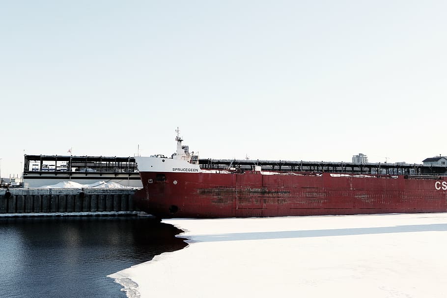 concrete, building, body, water, red, white, ship, daytime, container, carrier