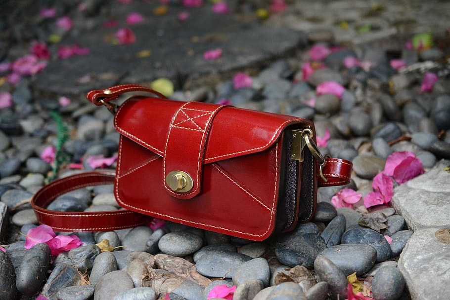red, bag, handbag, solid, focus on foreground, rock, day, personal accessory, rock - object, stone - object