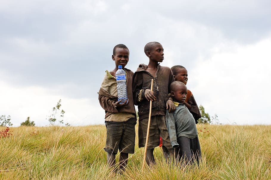 boy, wearing, yellow, top, green, grass field, children, burundi, bottle, water