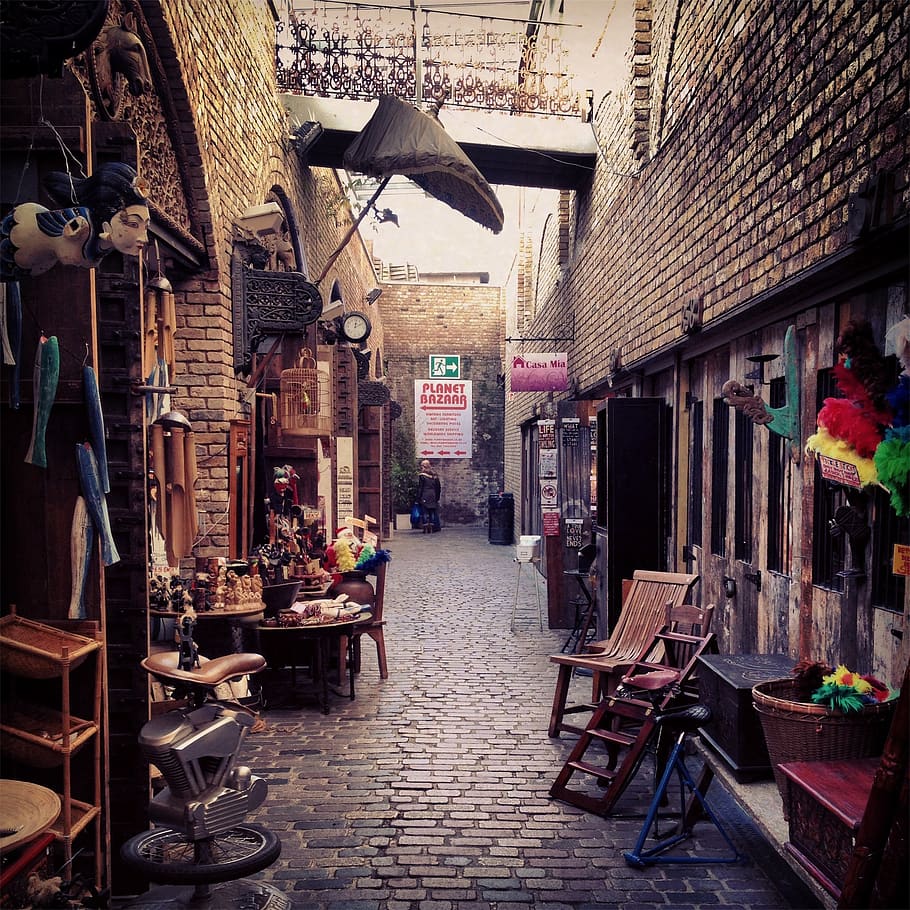 market, bazaar, shops, stores, merchandise, goods, alley, cobblestone, chairs, birdcage