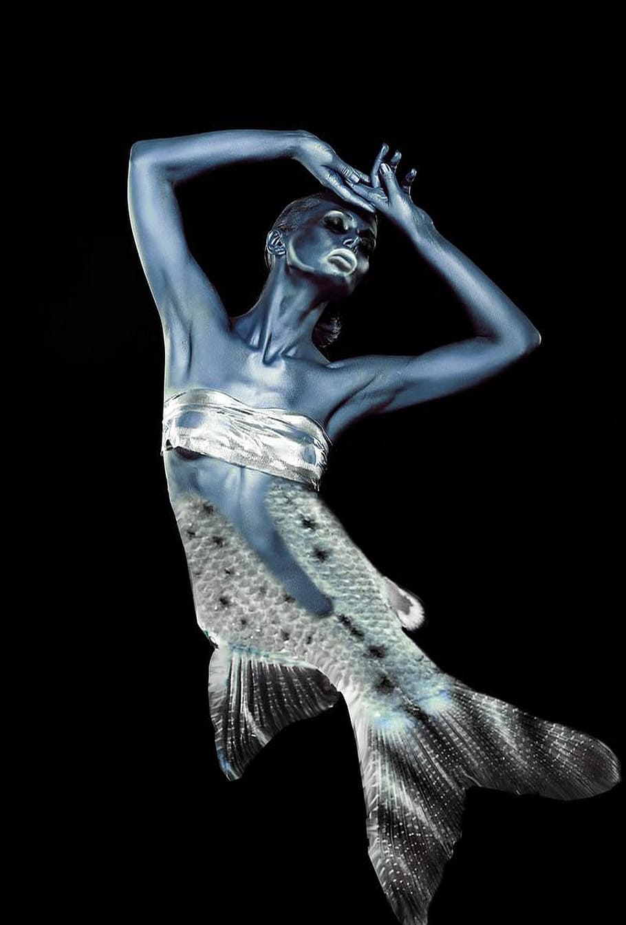 mermaid, fish man, woman, mythical creatures, studio shot, black background, indoors, one person, arms raised, human arm