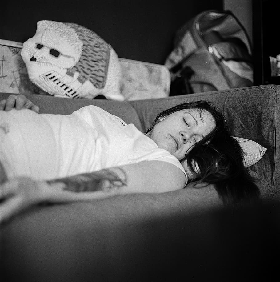 woman, wearing, white, cap-sleeved shirt, sleeping, sofa, young lady, female, young, lady