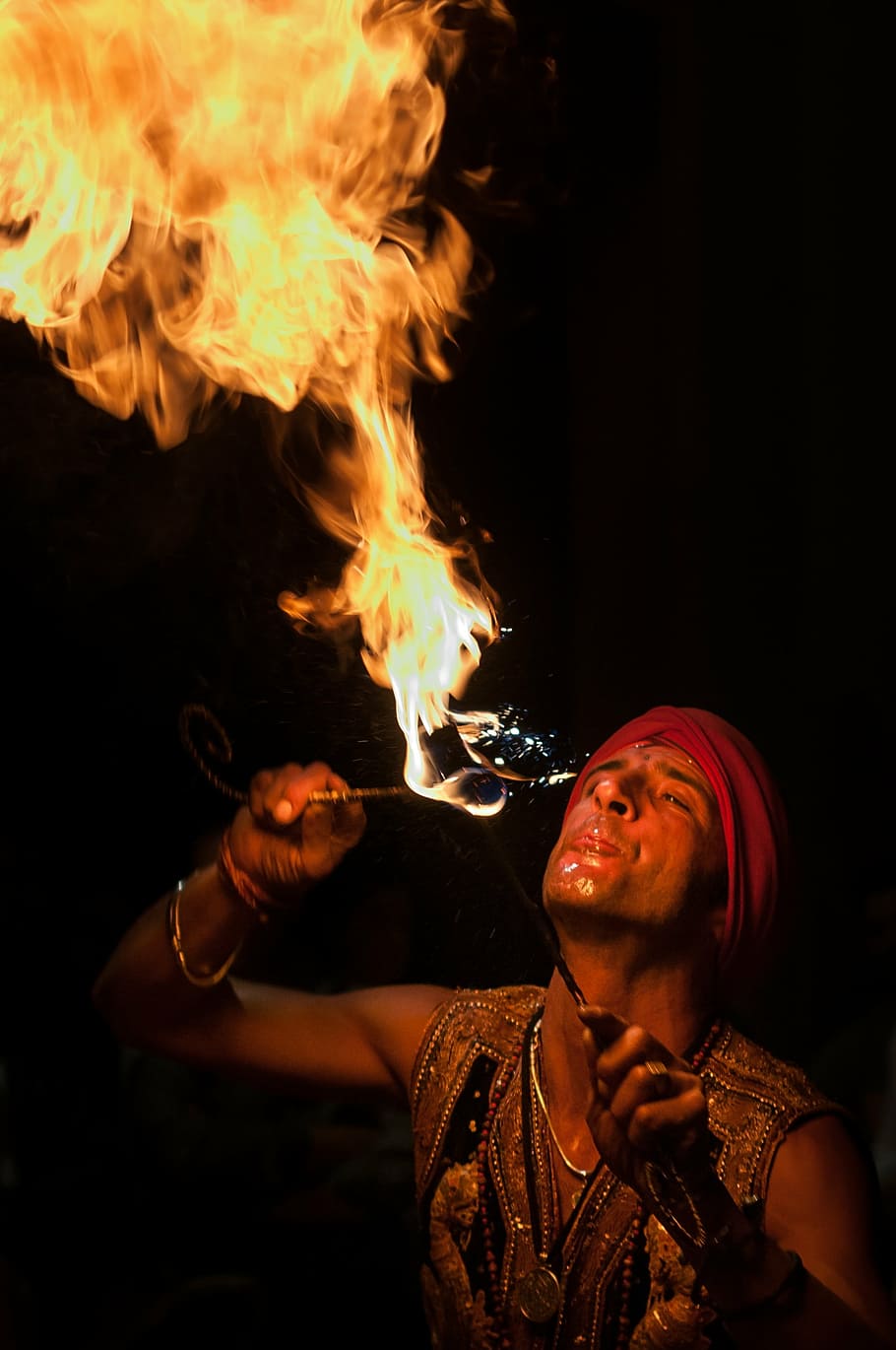 man, wearing, red, bandana breathing fire, fire eaters, artist, juggler, fire, flame, burning