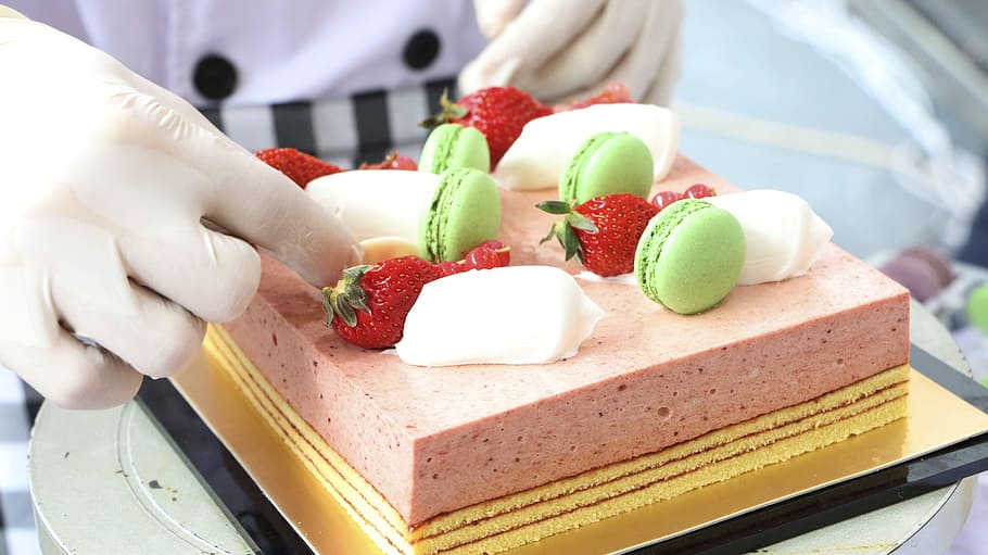 person, putting, strawberry, cake, cake baker, dessert, gourmet, baking, delicious, macaron