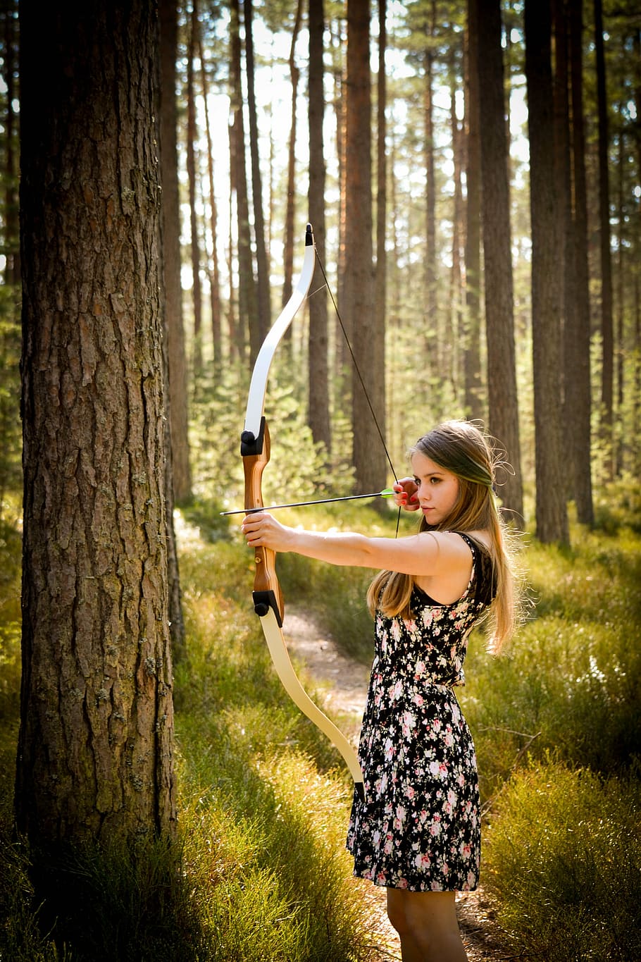 woman, black, floral, mini dress, holding, long, bow, standing, tree, forest