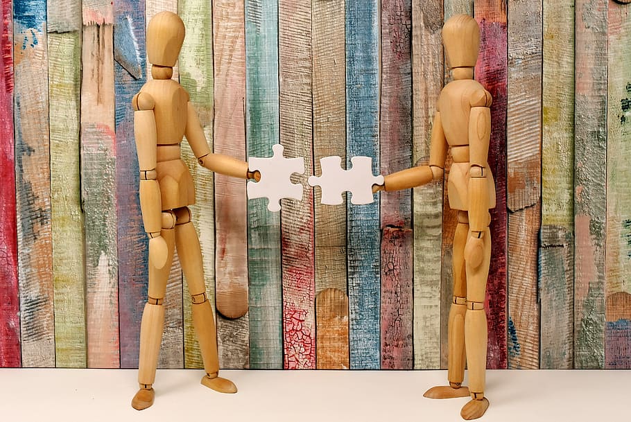 closeup, two, brown, wooden, mannequins, teamwork, fit together, together, hand in hand, connect
