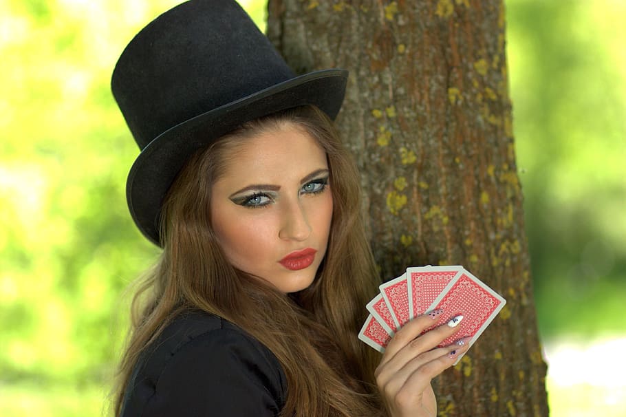 woman, black, top, hat, holding, cards, tree, girl, topper, playing cards
