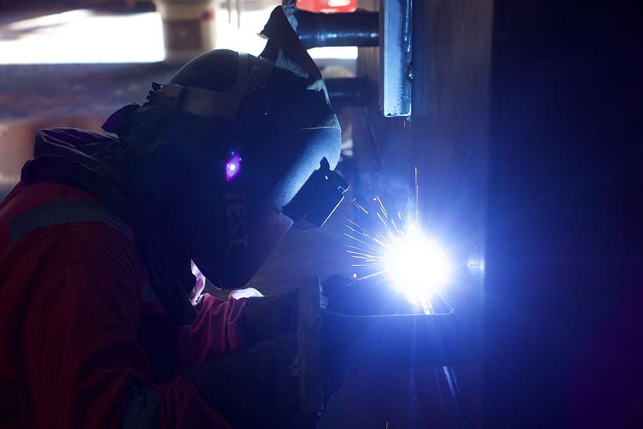 person welding metal, welder, engineer, industry, industrial, engineering, welding, equipment, worker, factory