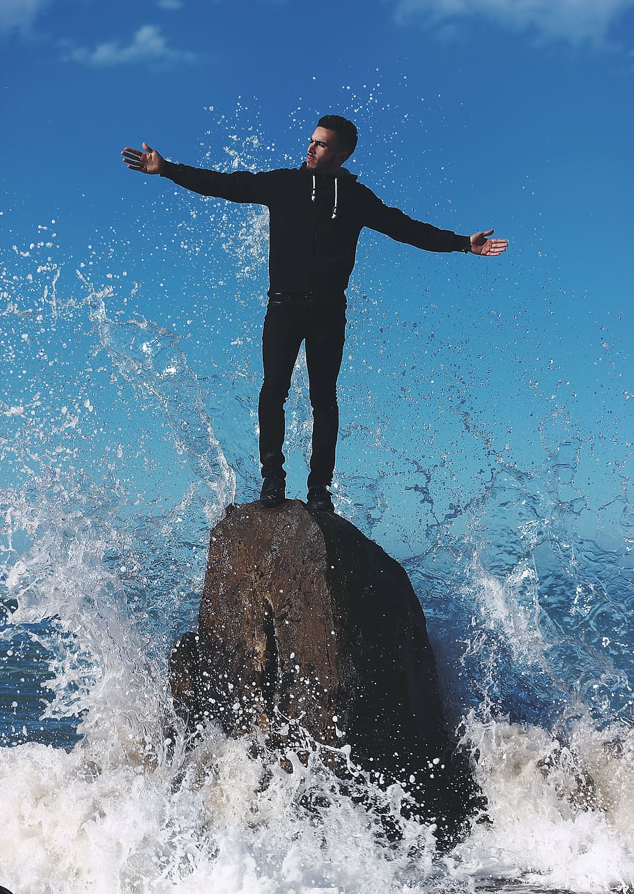 man, standing, rock, water, guy, wave, splash, formation, beach, sea