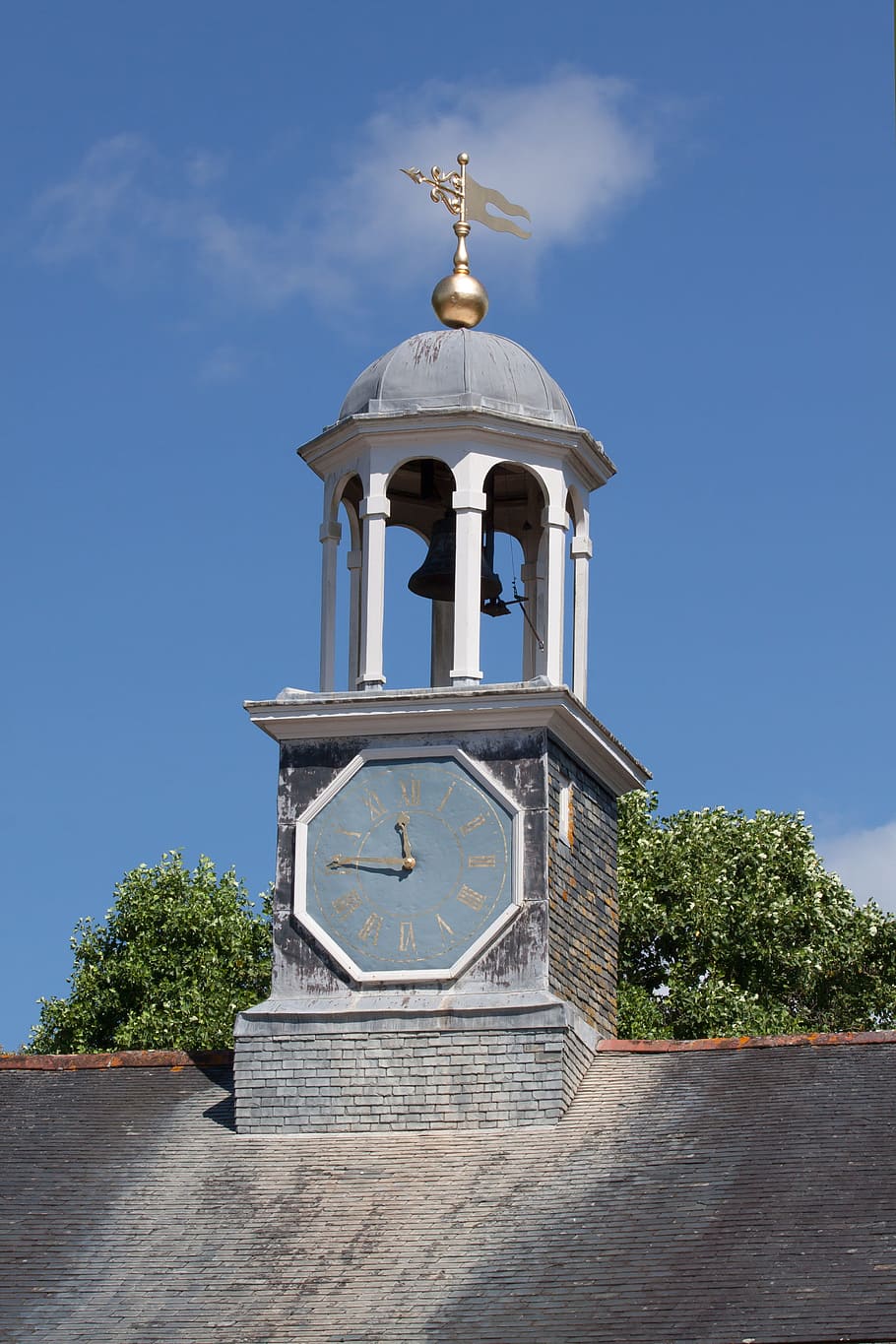 Turret, Columnar, Clock, octagonal, pointer, gold, roman numerals, weathervane, sunny, sky
