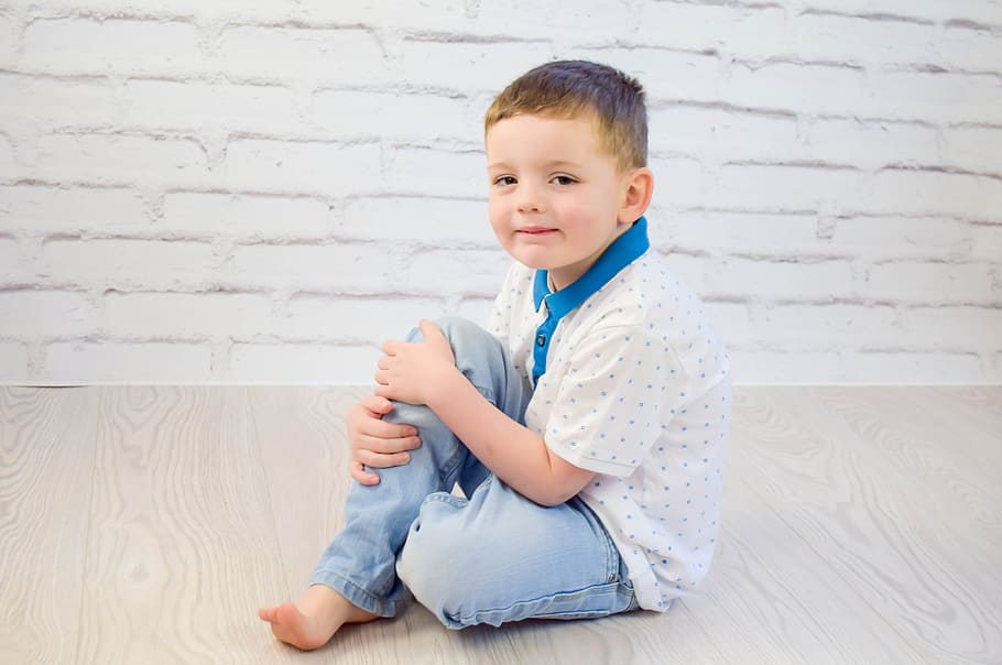 white, blue, polka-dots polo shirt, jeans, sitting, brown, wooden, floor, Child, Boy