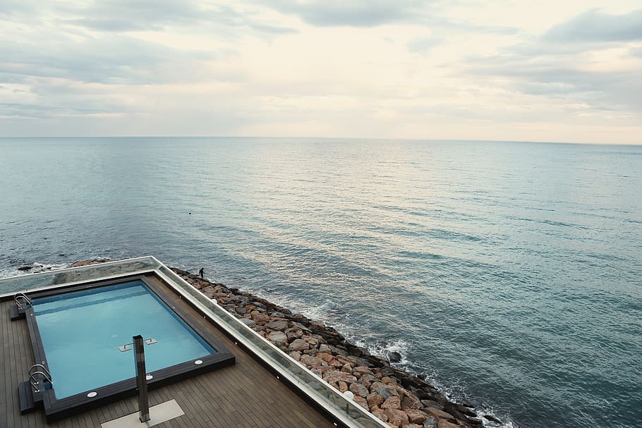 swimming pool, wood, deck, railing, rocks, coast, water, sea, ocean, sky