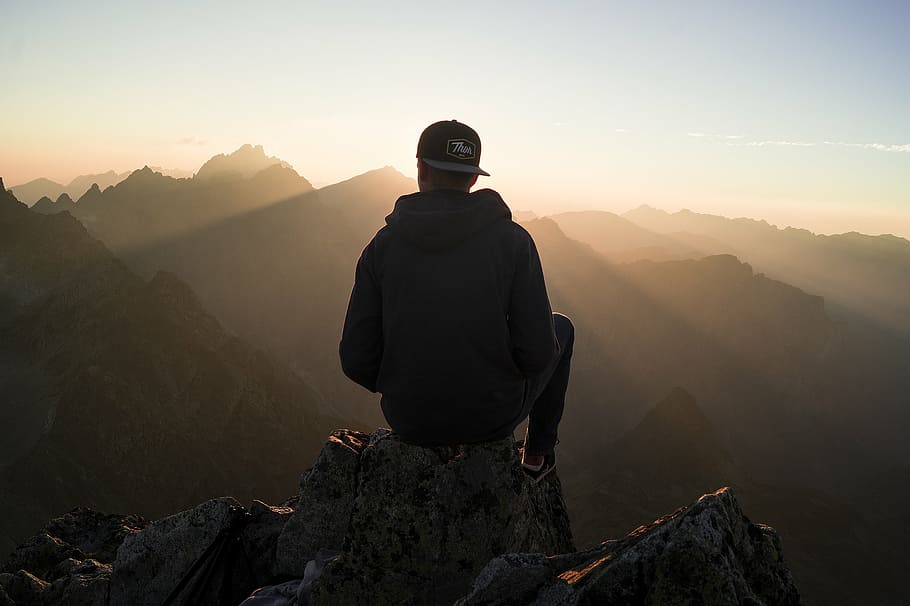 silhouette photography, person, sitting, top, mountain, macro, shot, photography, hoodie, daytime