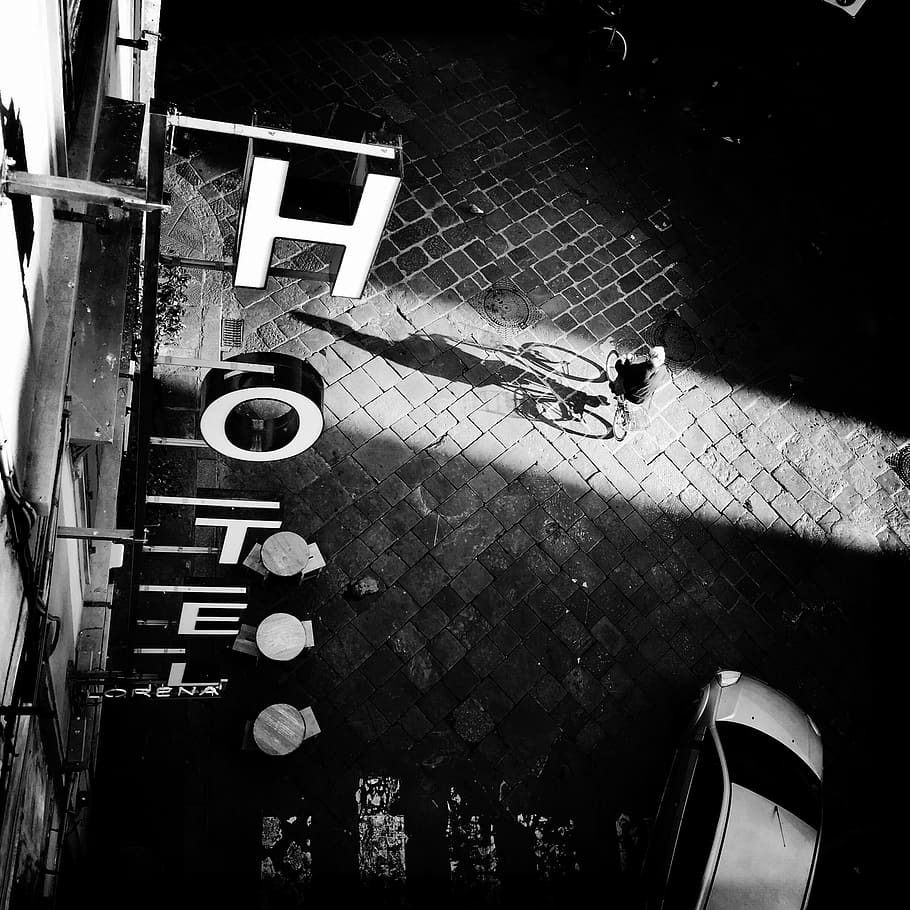 building, structure, black and white, signage, font, hotel, dark, night, light, table