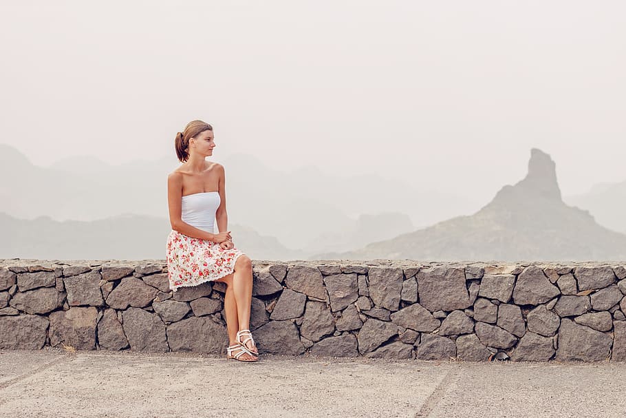 woman, white, sleeveless dress, sitting, stone bench, rock, fence, young woman, excursion, naturally
