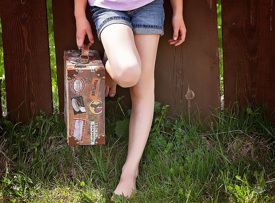person, holding, brief, case, feet, barefoot, fence, grass, luggage, wait