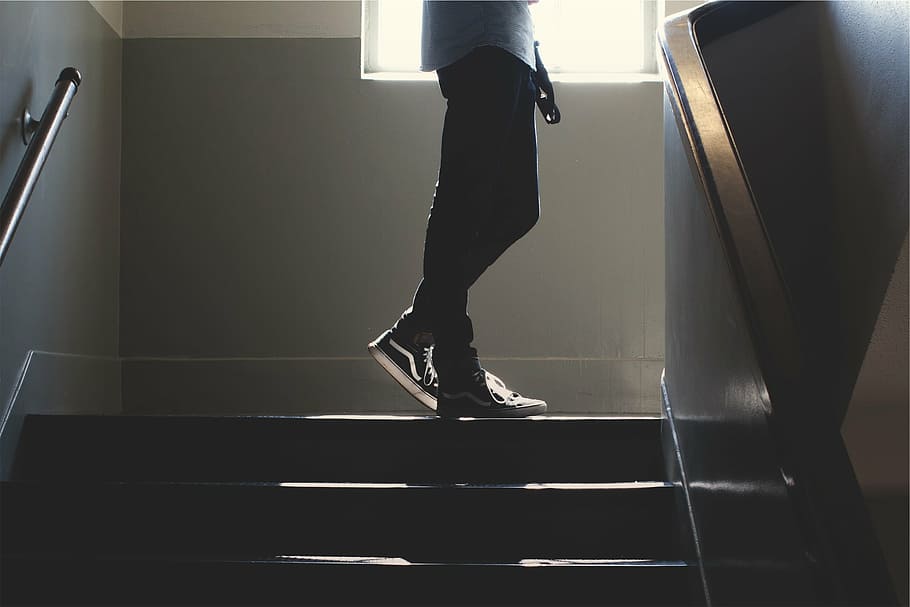 standing man upstairs, person, black, pants, vans, sk, hi, standing, top, staircase