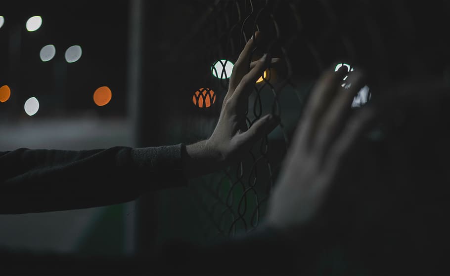 closeup, person, hand, holding, fence, hands, bokeh, lights, night, dark